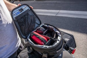 Photo showing man standing next to motorcycle - tail bag with dividers installed